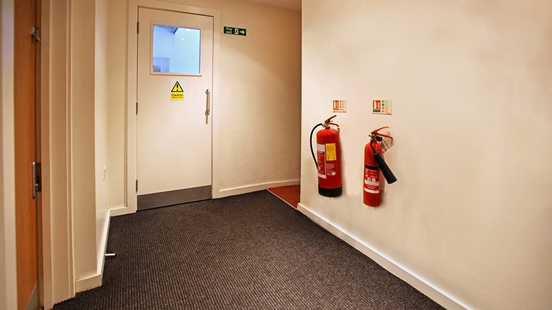 Fire Extinguishers Mounted on Wall